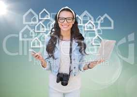 Woman with phone and laptop against white house graphics blue green background with flare