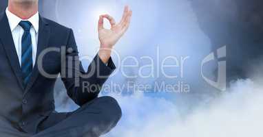 Businessman Meditating with clouds