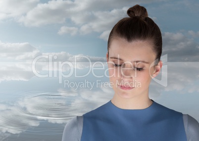 Woman Meditating peacefully by water ripple of clouds