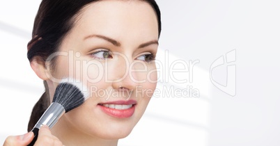 Woman with make up brush against white background