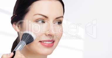Woman with make up brush against white background