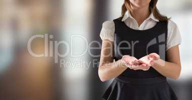 Business woman mid section in pinafore holding out hands in blurry room