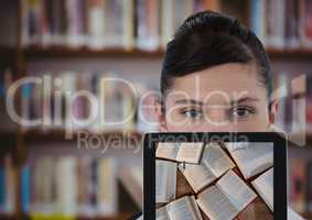 Woman with tablet showing open books against blurry bookshelf