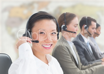 Travel agents with headsets against blurry map