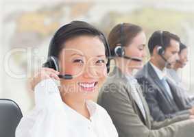 Travel agents with headsets against blurry map