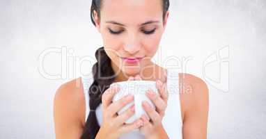 Close up of woman with white mug against white wall