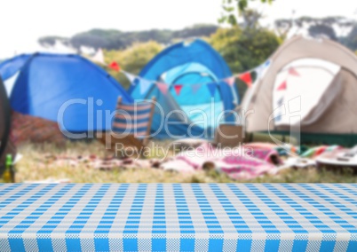 Picnic table against blurry campsite