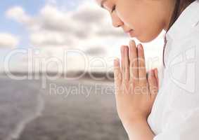 Woman praying Yoga Meditating by sea
