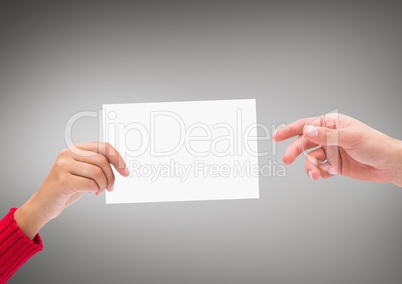 Hands with blank card against grey background