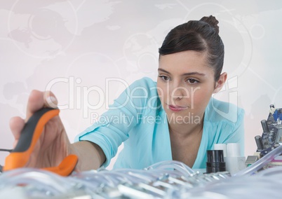 Woman with electronics and pliers against white background with interface