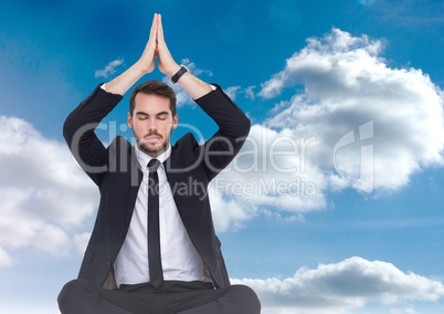 Businessman Meditating by clouds