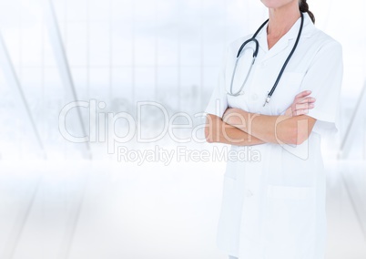 Doctor mid section with arms folded against blurry window