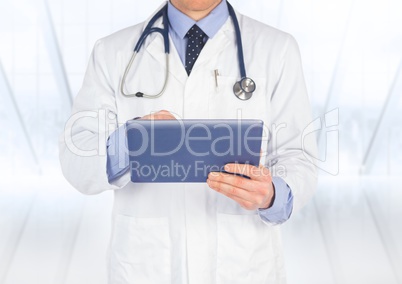 Doctor mid section with tablet against blurry window
