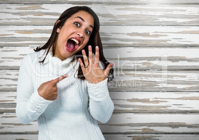 Engaged Woman with ring excited against wood