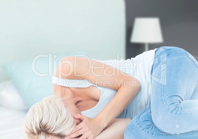 Sad woman crying on bed in bedroom
