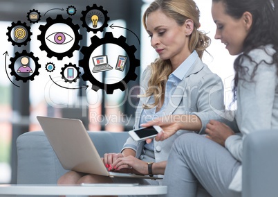 Two business women with laptop and black gear graphics