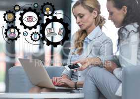 Two business women with laptop and black gear graphics