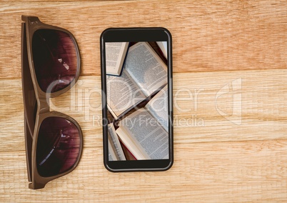 Sunglasses and phone showing open books