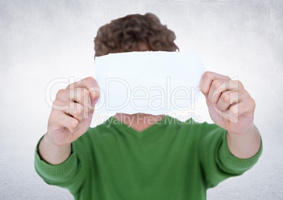 Man holding ripped paper over face against white background