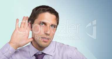 Man in lavender shirt with hand at ear against blue background