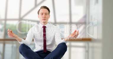Businessman Meditating by windows office