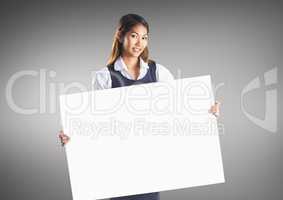 Business woman with large blank card against grey background
