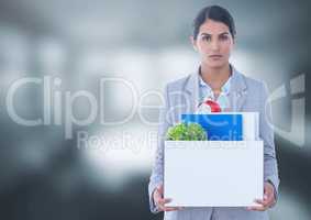 Sad woman redundant  with box of office job equipment