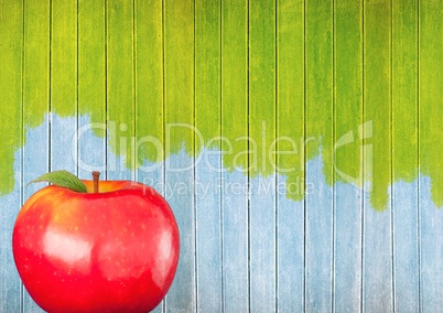 apple against colourful painted wood