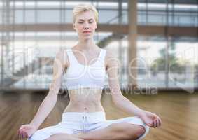 woman Meditating peacefully in gym