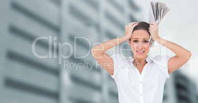 Stressed woman in front of tall buildings