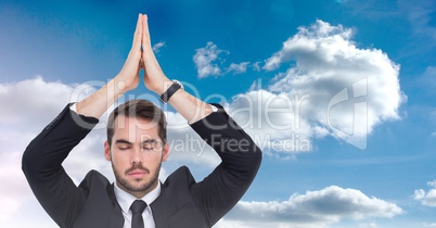 Businessman Meditating yoga in front of sky