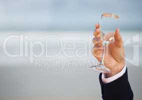 Wedding groom holding champagne celebrating by sea