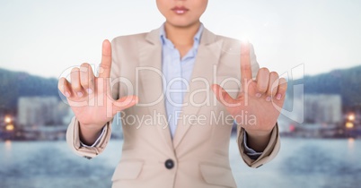 Business woman mid section with flare against skyline