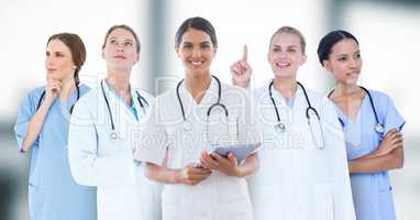 Group of doctors against blurry grey window