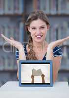 Woman at table with tablet showing hands with book against blurry bookshelf with blue overlay