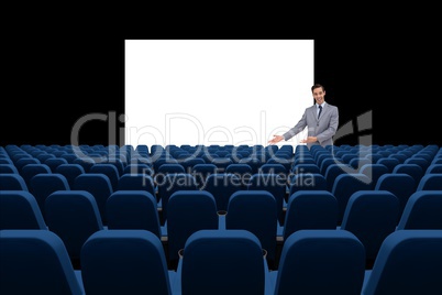 Businessman presenting at blank board in front of 3d empty chairs