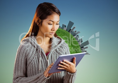 Woman with tablet against globe and buildings and blue green background