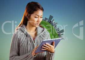 Woman with tablet against globe and buildings and blue green background
