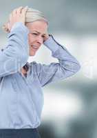 Stressed woman with hands on head against blurred background