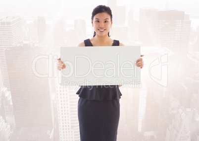 Business woman with black card against skyline