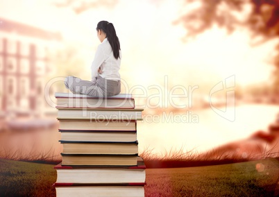 Businesswoman sitting on Books stacked by water