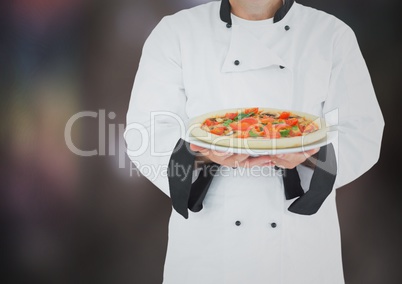Chef with pizza against blurry dark grey background