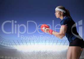 Table tennis player against stadium with bright lights and dark blue sky