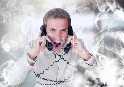 Stressed man on telephones with swirls of smoke illuminated