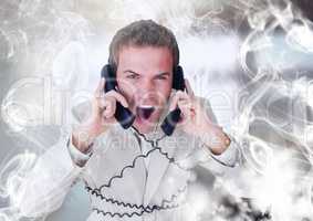 Stressed man on telephones with swirls of smoke illuminated