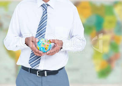 Travel agent mid section holding globe against blurry map