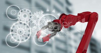 Red robot claw against white cog graphics and blurry building