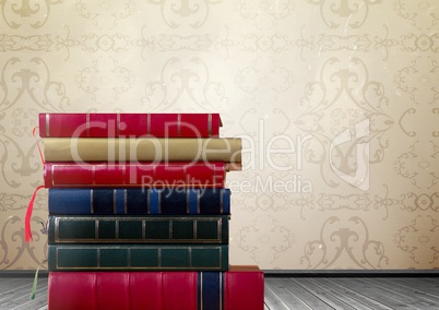 Books stacked by rustic wallpaper
