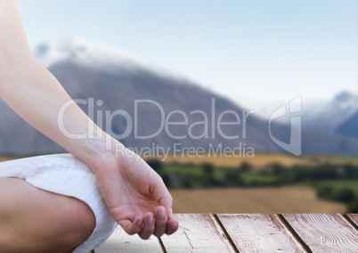 Womans hand Meditating by mountains