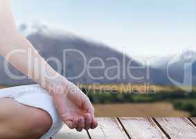 Womans hand Meditating by mountains